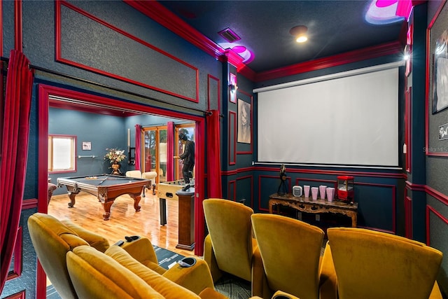 home theater with crown molding, hardwood / wood-style floors, and billiards