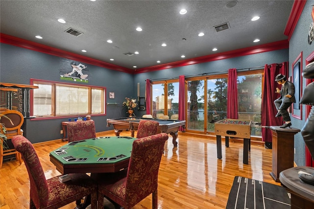 recreation room featuring ornamental molding, a textured ceiling, light wood-type flooring, and billiards