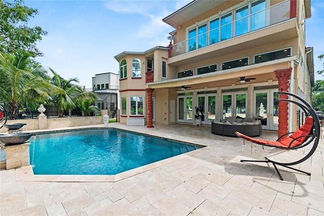 view of swimming pool featuring a patio, an outdoor hangout area, french doors, and ceiling fan