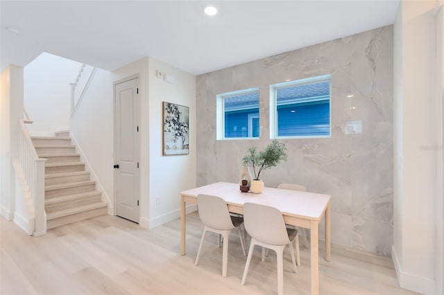 dining space with light hardwood / wood-style floors