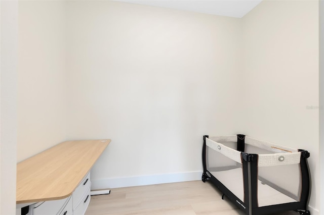 clothes washing area featuring light wood-type flooring