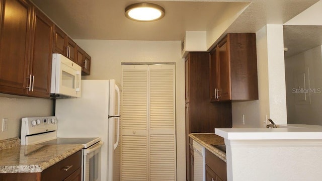 kitchen with white appliances and kitchen peninsula