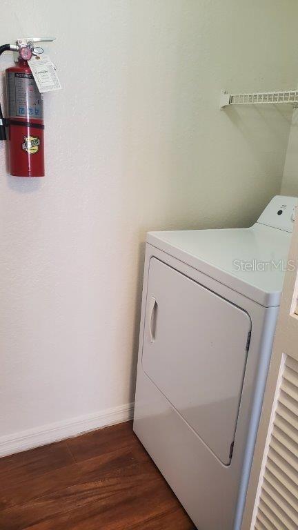 laundry room featuring dark hardwood / wood-style flooring and washer / dryer