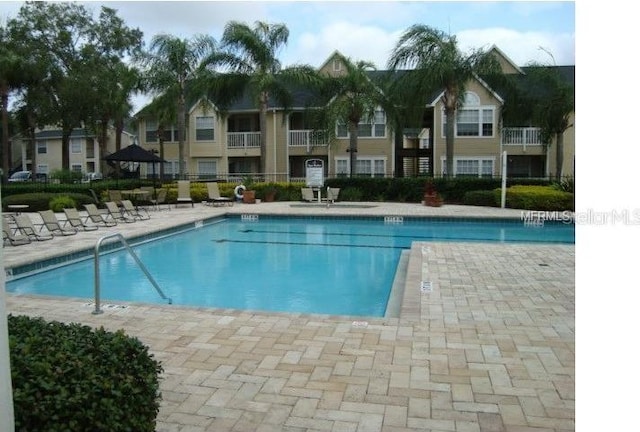 view of swimming pool with a patio