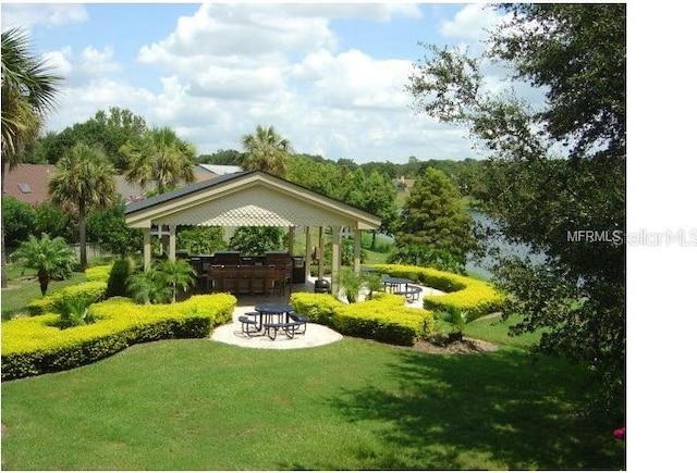 view of yard featuring a gazebo and a bar