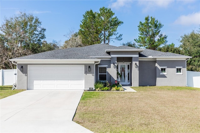 view of front of house with a garage and a front yard