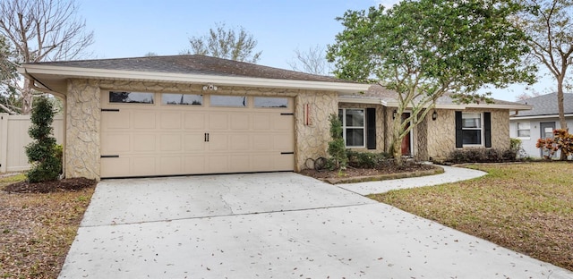 ranch-style house featuring a garage and a front lawn