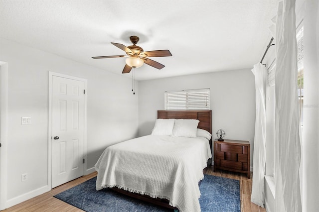 bedroom featuring hardwood / wood-style flooring and ceiling fan