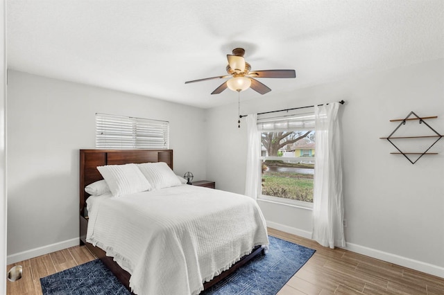 bedroom featuring ceiling fan and wood-type flooring