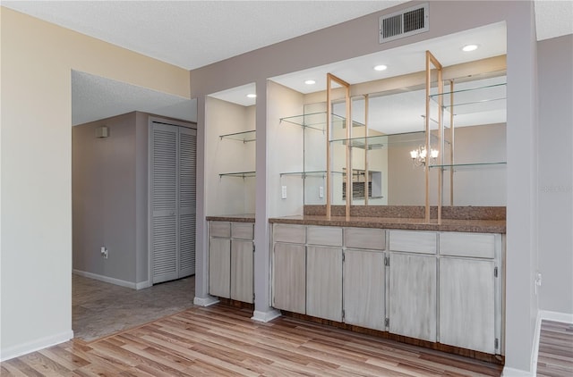 bathroom with hardwood / wood-style flooring, vanity, and a textured ceiling