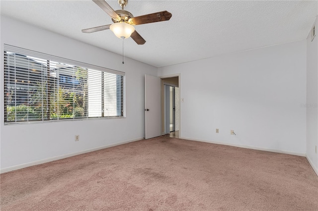 unfurnished room featuring ceiling fan, a textured ceiling, and carpet flooring