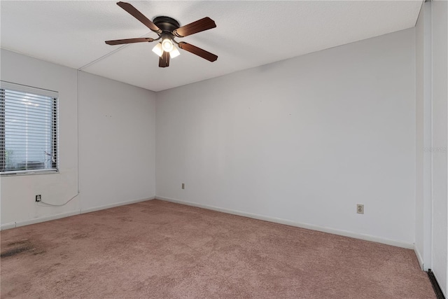 unfurnished room featuring ceiling fan, light carpet, and a textured ceiling