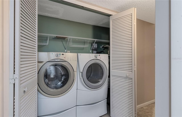 laundry area featuring independent washer and dryer, a textured ceiling, and light tile patterned flooring