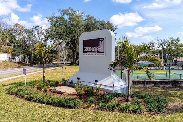 community sign featuring a lawn