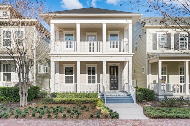 view of front of property with a balcony and covered porch