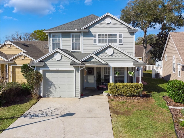 view of property with a front yard and central AC unit