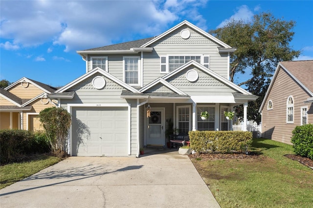 view of front facade featuring a garage, a front yard, and a porch