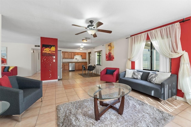 living room featuring sink, light tile patterned floors, and ceiling fan