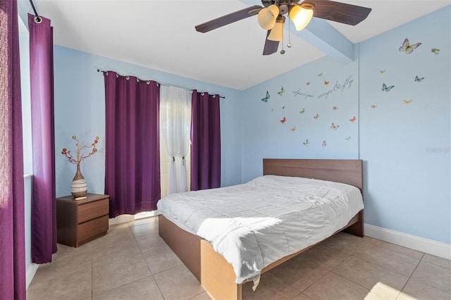 bedroom with light tile patterned flooring, ceiling fan, and beamed ceiling