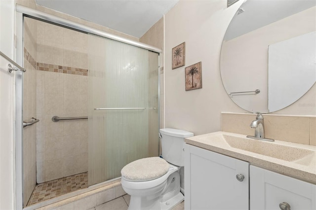 bathroom with walk in shower, vanity, and toilet