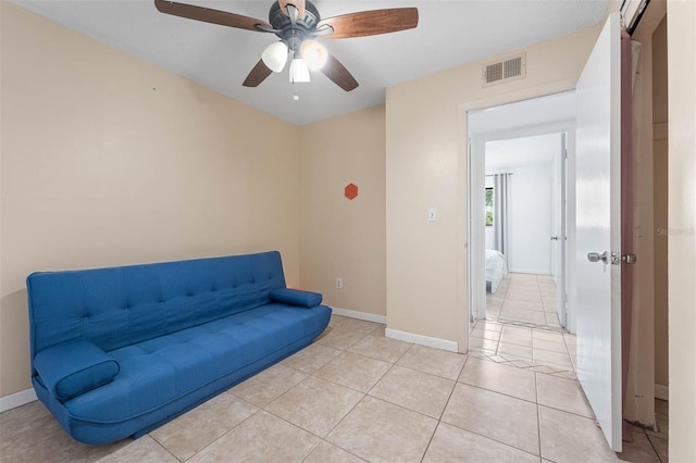 sitting room featuring light tile patterned floors and ceiling fan