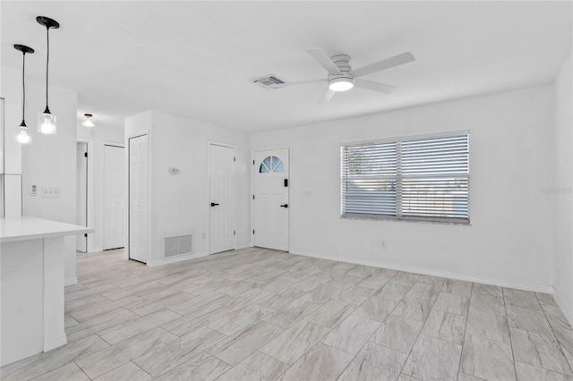 interior space featuring ceiling fan