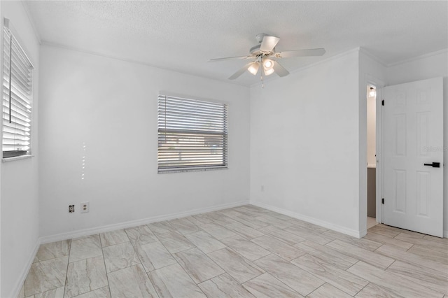 empty room featuring ceiling fan, ornamental molding, and a textured ceiling