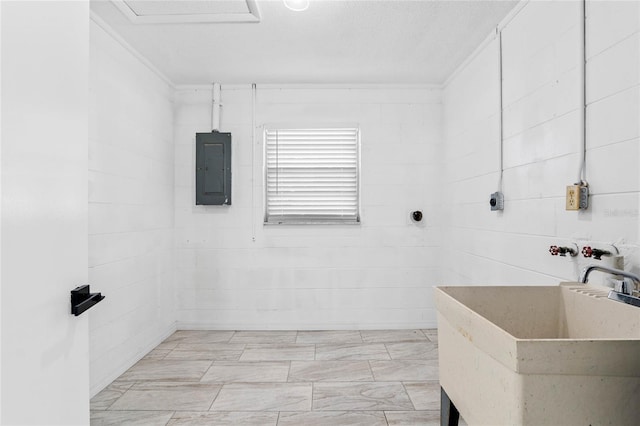 bathroom featuring sink, electric panel, and a textured ceiling