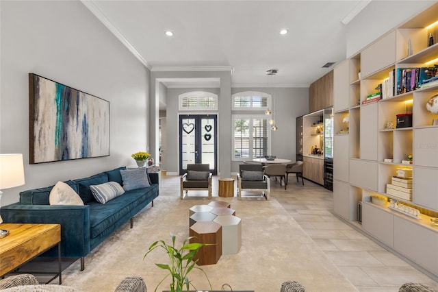 tiled living room with ornamental molding and french doors