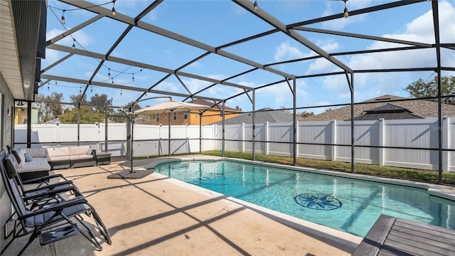 view of swimming pool featuring a patio area, outdoor lounge area, and glass enclosure