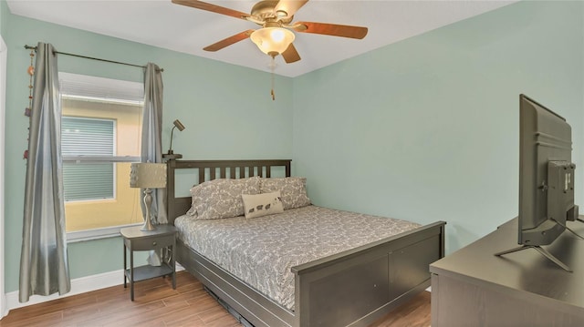 bedroom featuring hardwood / wood-style flooring and ceiling fan