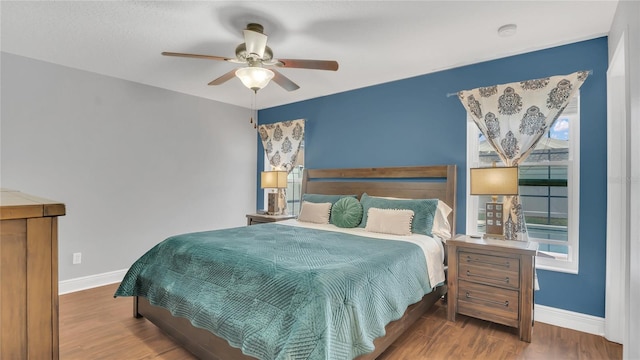 bedroom with ceiling fan and wood-type flooring