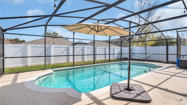 view of swimming pool featuring a lanai and a patio