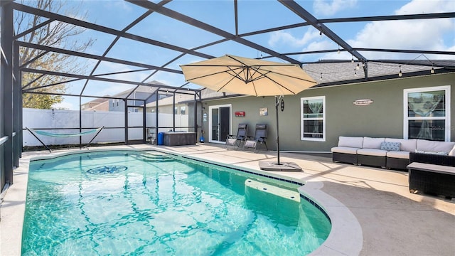 view of swimming pool with a patio area, outdoor lounge area, and glass enclosure