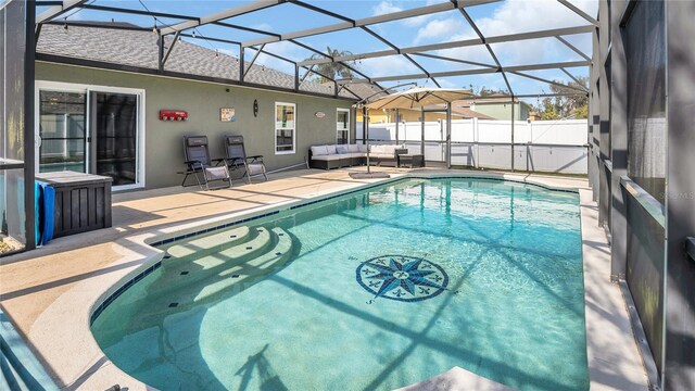 view of pool featuring outdoor lounge area, a lanai, and a patio