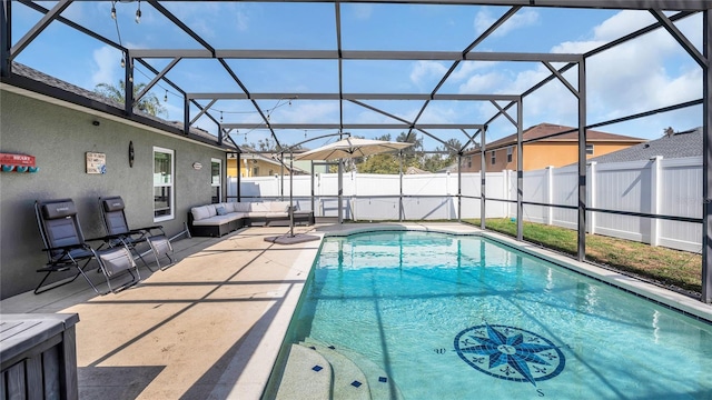 view of pool with an outdoor living space, a lanai, and a patio area