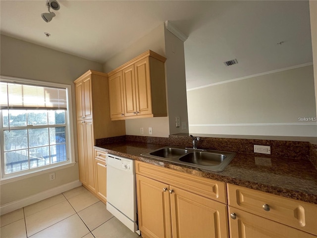 kitchen featuring sink, light tile patterned floors, white dishwasher, light brown cabinetry, and dark stone counters