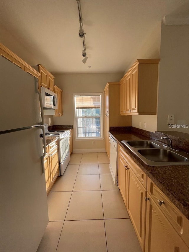 kitchen with sink, light brown cabinets, white appliances, and light tile patterned floors