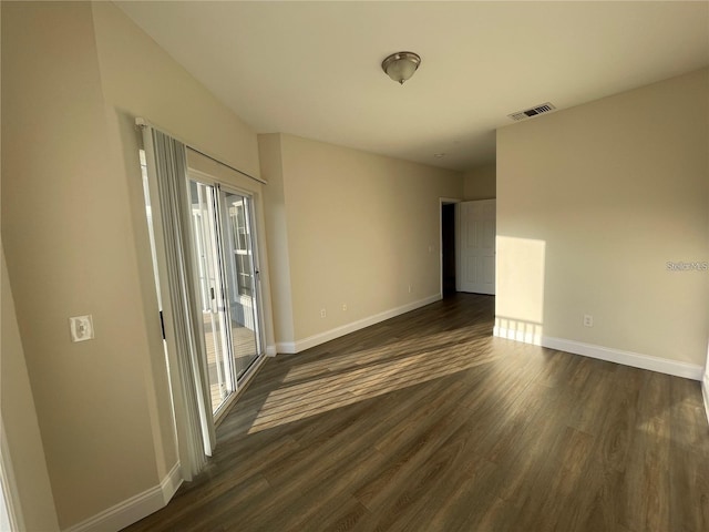 spare room featuring dark wood-type flooring