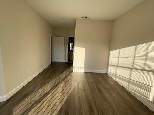 empty room featuring dark wood-type flooring