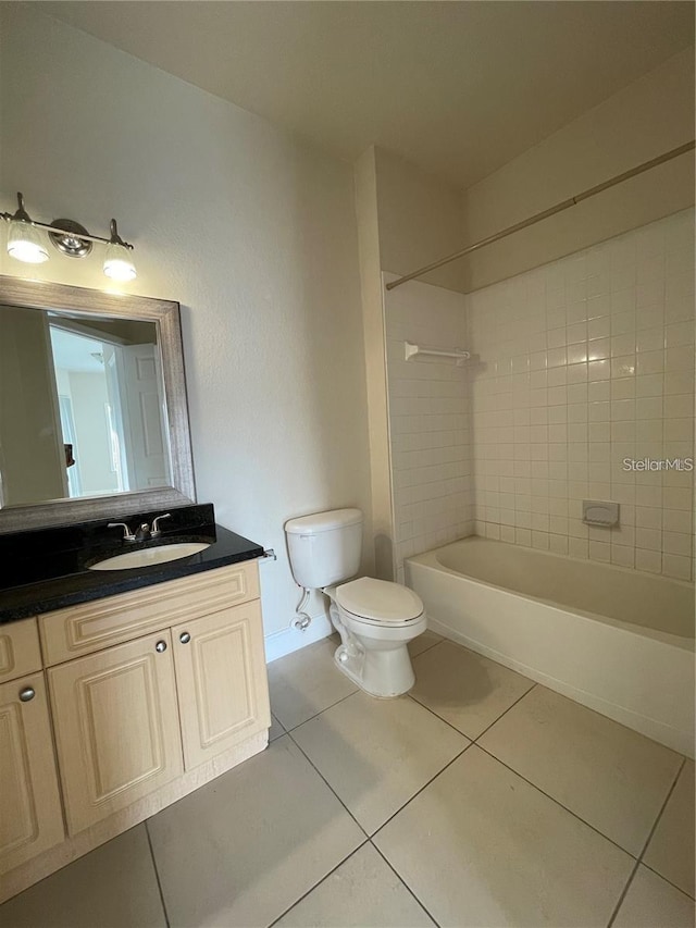 full bathroom with vanity, toilet, tiled shower / bath combo, and tile patterned flooring