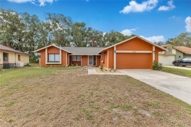 ranch-style house with a garage, cooling unit, and a front lawn