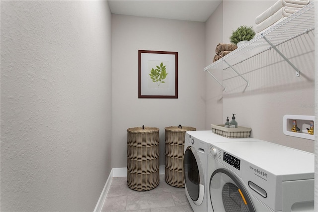 clothes washing area featuring washer and dryer