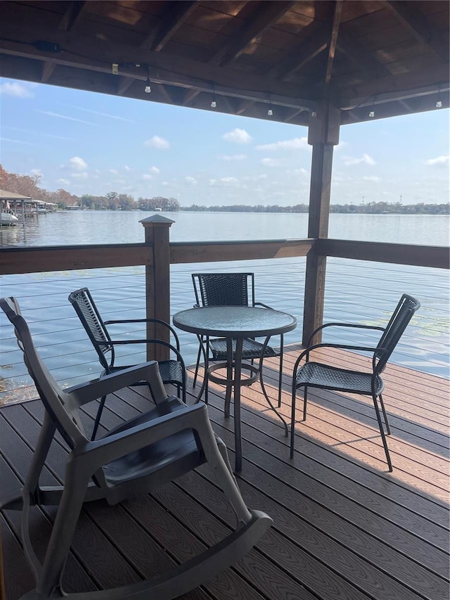 wooden terrace featuring a gazebo and a water view