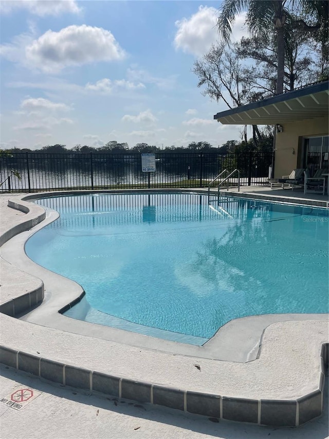 view of pool with a water view