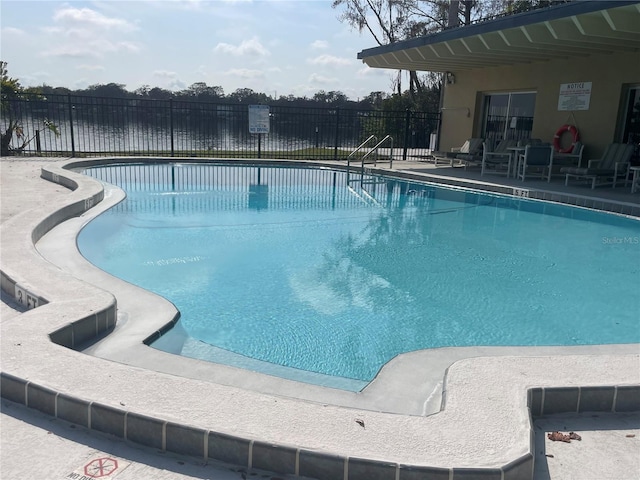 view of swimming pool with a water view