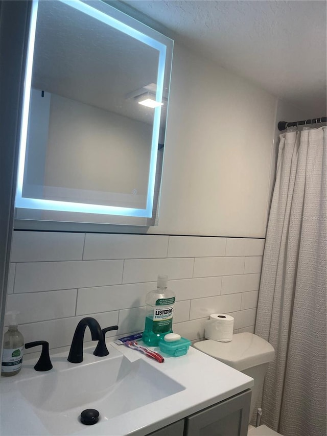 bathroom featuring vanity, a shower with curtain, and toilet