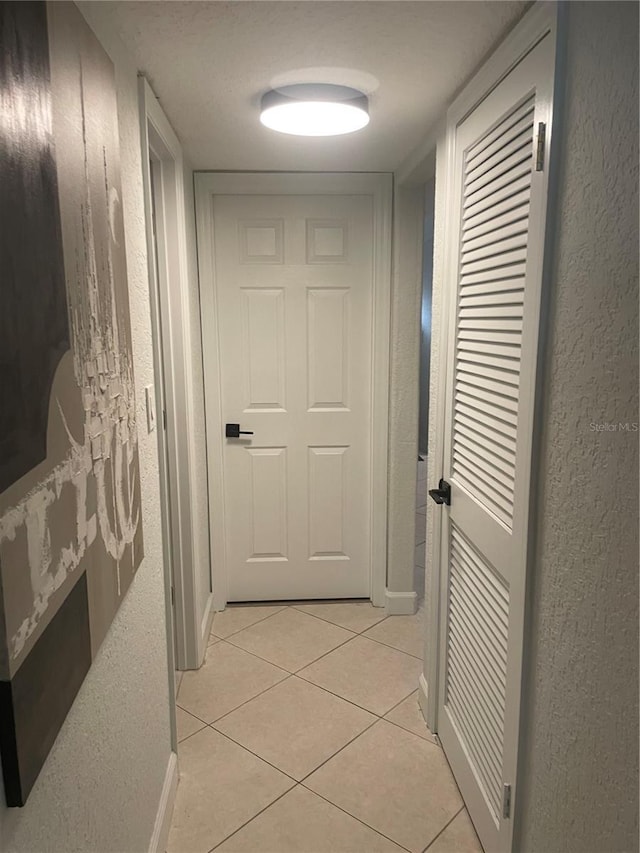 hallway with light tile patterned floors