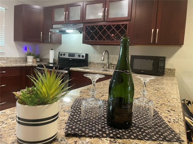 kitchen with sink, electric range, and light stone counters