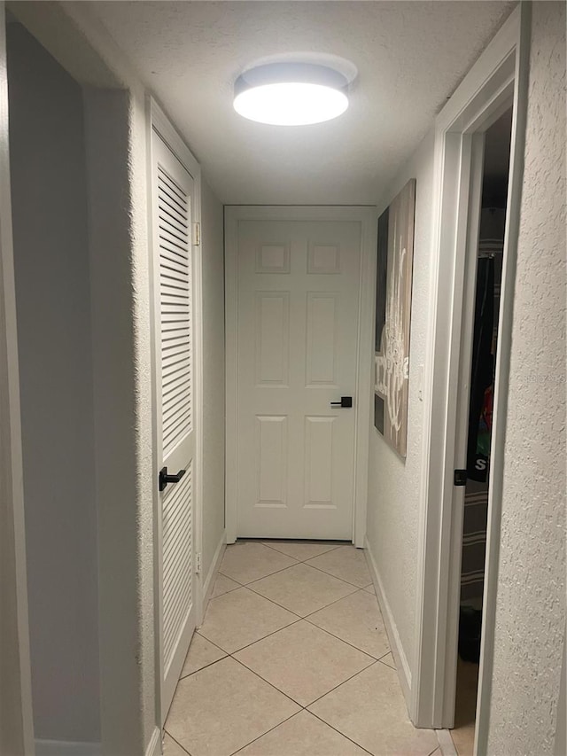 hallway featuring light tile patterned flooring